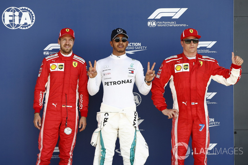 Sebastian Vettel, Ferrari, Polesetter Lewis Hamilton, Mercedes AMG F1, and Kimi Raikkonen, Ferrari, celebrate after qualifying