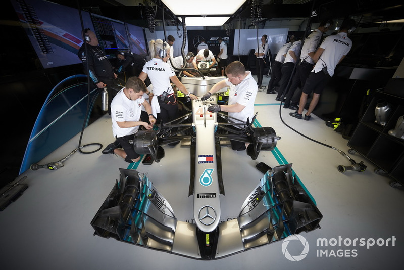 Engineers work on the car of Lewis Hamilton, Mercedes AMG F1 W09