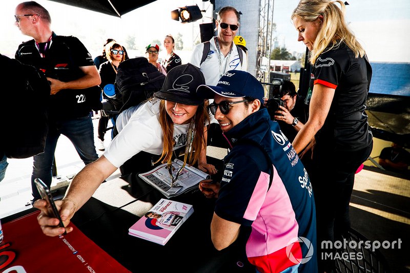 Sergio Perez, Racing Point poses for a selfie with a fan