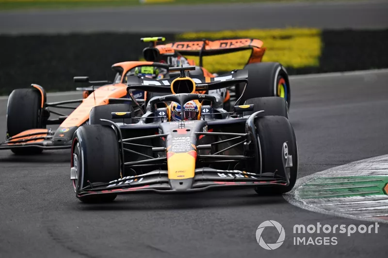 Max Verstappen, Red Bull Racing RB20 defends from Lando Norris, McLaren MCL38 