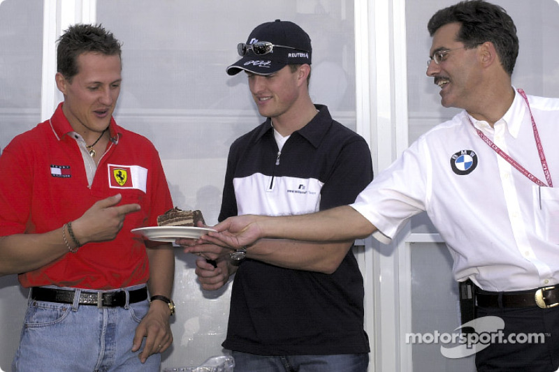 Michael Schumacher, Ralf Schumacher and Mario Theissen celebrating Ralf's 26th birthday