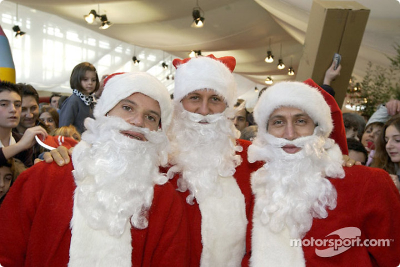 The traditional Childrenâ€™s Christmas at Ferrari: Rubens Barrichello, Michael Schumacher and Luca B