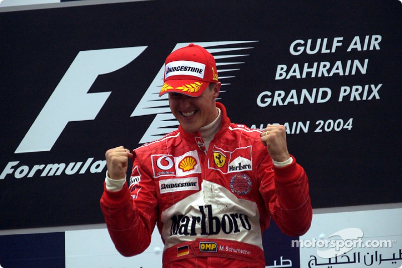 Podium: race winner Michael Schumacher celebrates