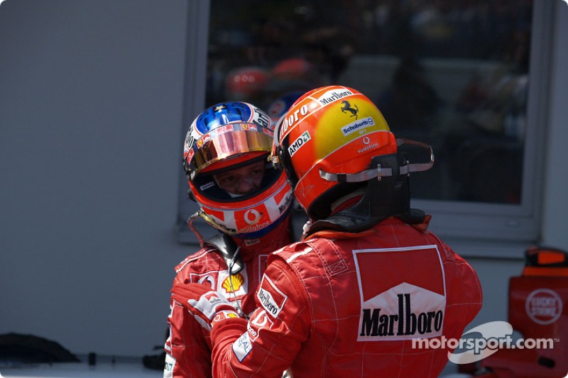 Race winner Michael Schumacher celebrates with Rubens Barrichello