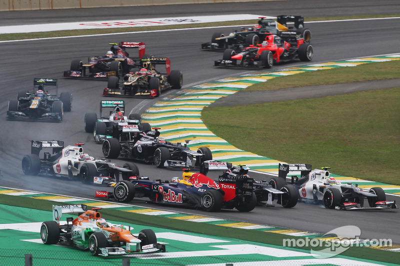 Sebastian Vettel, Red Bull Racing survives a crash with Sergio Perez, Sauber and Bruno Senna, Williams at the start of the race