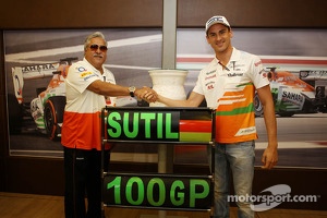 Dr. Vijay Mallya, Sahara Force India F1 Team Owner presents a ceramic wheel rim, signed by the team, to Adrian Sutil, Sahara Force India F1, who is celebrating his 100th GP