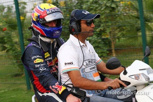 Mark Webber, Red Bull Racing heads back to the paddock after he retired from the race