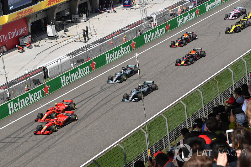 Sebastian Vettel, Ferrari SF71H and Kimi Raikkonen, Ferrari SF71H lead at the start of the race