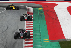 Romain Grosjean, Haas F1 Team VF-18, leads Kevin Magnussen, Haas F1 Team VF-18, and Nico Hulkenberg, Renault Sport F1 Team R.S. 18, to the grid
