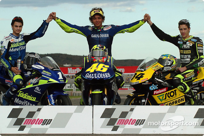 The 2004 champions: MotoGP 500cc champion Valentino Rossi, with 250cc champion Daniel Pedrosa and 12