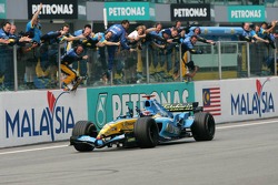 Race winner Fernando Alonso celebrates