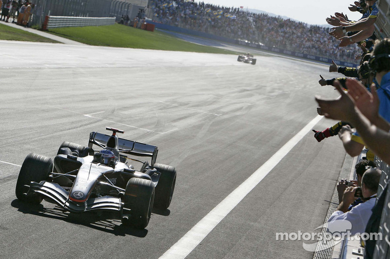 Race winner Kimi Raikkonen celebrates