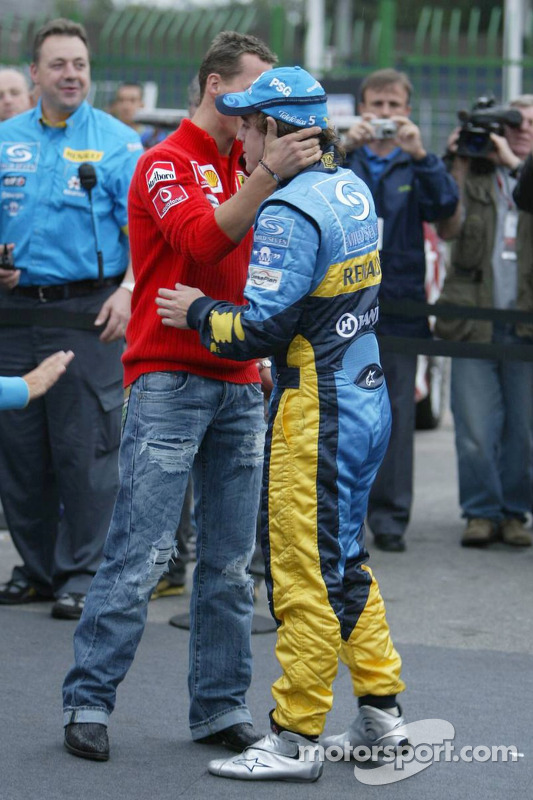 The passing of the crown: Michael Schumacher congratulates 2005 World Champion Fernando Alonso