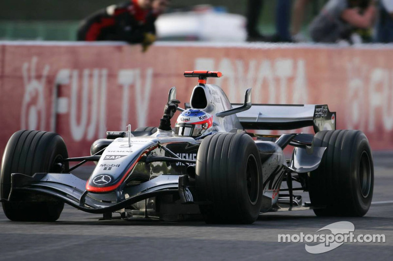 Race winner Kimi Raikkonen celebrates