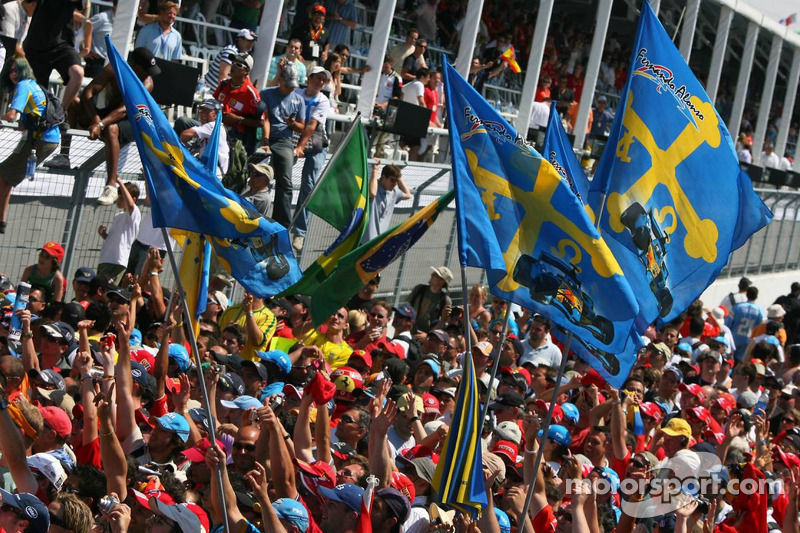 Fans of Fernando Alonso celebrate