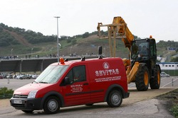 Recovery vehicles wait to be called upon