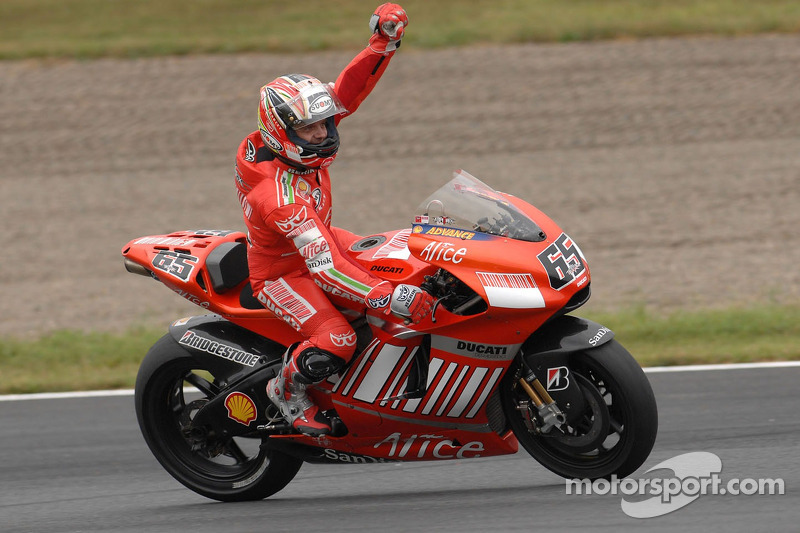 Race winner Loris Capirossi celebrates