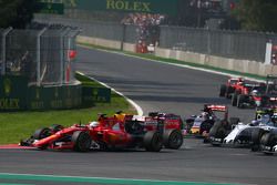 Sebastian Vettel, Ferrari SF15-T and Daniel Ricciardo, Red Bull Racing RB11 make contact at the start of the race